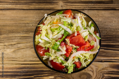 Fresh vegetable salad on wooden table