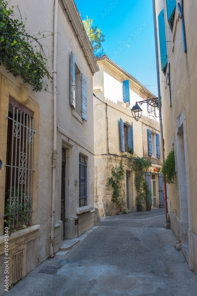 Arles in the south of France, typical paved side street of the city center
