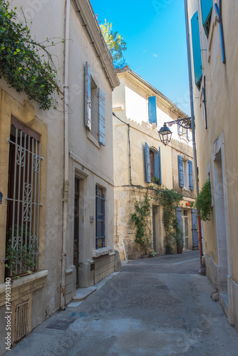 Fototapeta Naklejka Na Ścianę i Meble -  Arles in the south of France, typical paved side street of the city center
