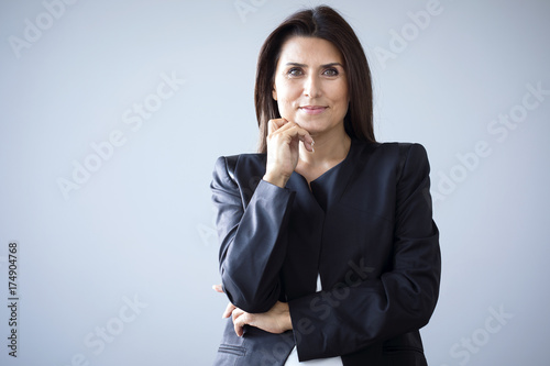 Portrait of businesswoman on grey background