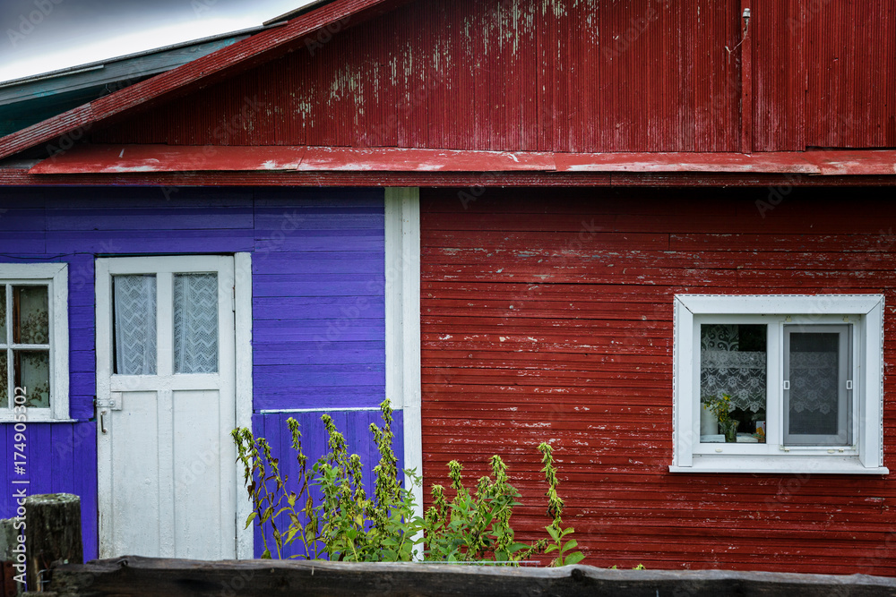 Fototapeta premium Multicolored wooden house in the village