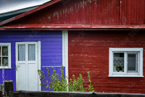 Fototapeta Naklejka Na Ścianę i Meble -  Multicolored wooden house in the village