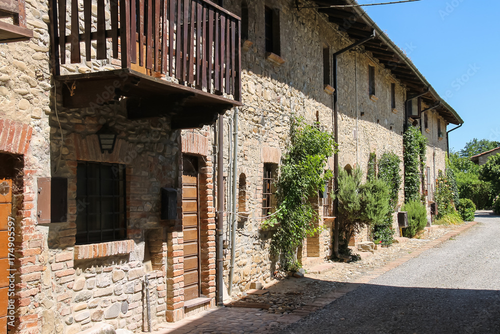 Old building with wooden balcony in medieval Grazzano Visconti, Italy Old building with wooden balcony in medieval Grazzano Visconti, Italy