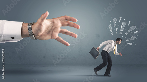 Business person getting away from a big hand