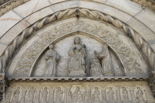Part of religious sculptural composition above entrance to chapel in medieval castle. Grazzano Visconti, Italy