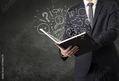 Businessman holding a book.