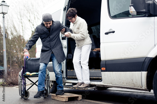 Nurse Helping Senior Man Exit A Van