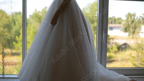 bride in the dress of the big window against the sky