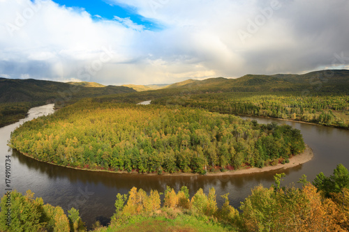 Fototapeta Naklejka Na Ścianę i Meble -  beautiful autumn landscape with curving river and forest under blue sky