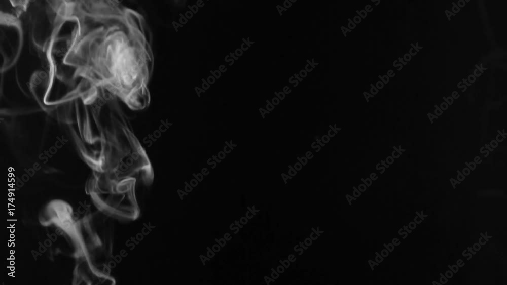 White smoke in the form of rings on a black background. White smoke in the form of rings on a black background.