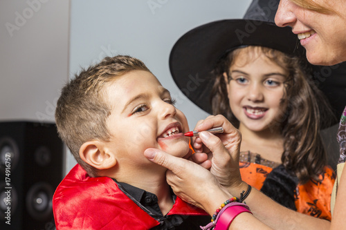 Mother painting faces at Halloween