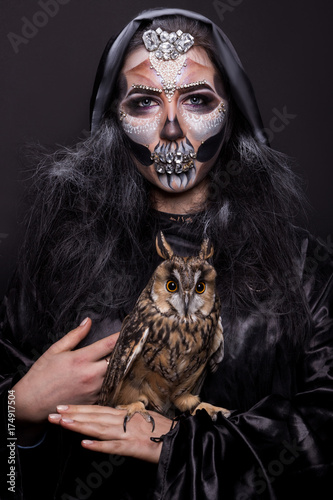 girl with a make-up for halloween with an owl in hands © dubogray1985
