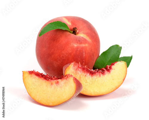Peach and slice with a green leaf isolated on white background