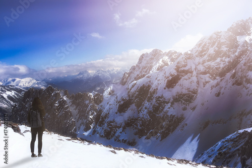 Woman has looking ice mountian and thinking on adventure and vacation time with blue sky and sunrise lighting background in the morning. Adventure and Recreation concept.