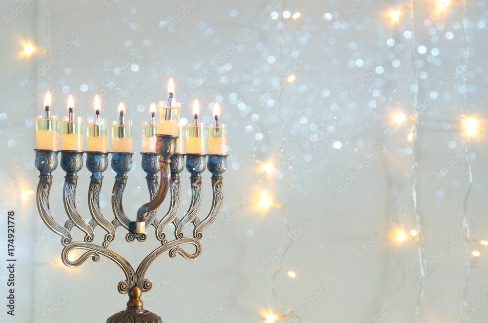Image of jewish holiday Hanukkah background with menorah (traditional candelabra) and burning candles Image of jewish holiday Hanukkah background with menorah (traditional candelabra) and burning candles