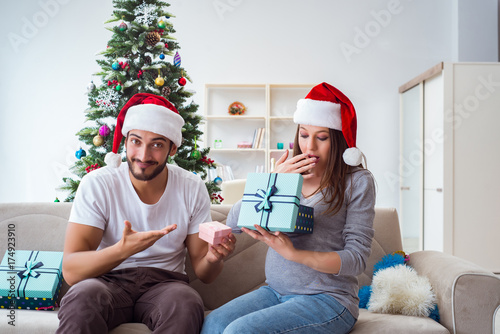 Young family expecting child baby celebrating christmas