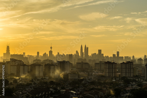 Photography Majestic sunset over silhouette of downtown Kuala Lumpur, Malaysia