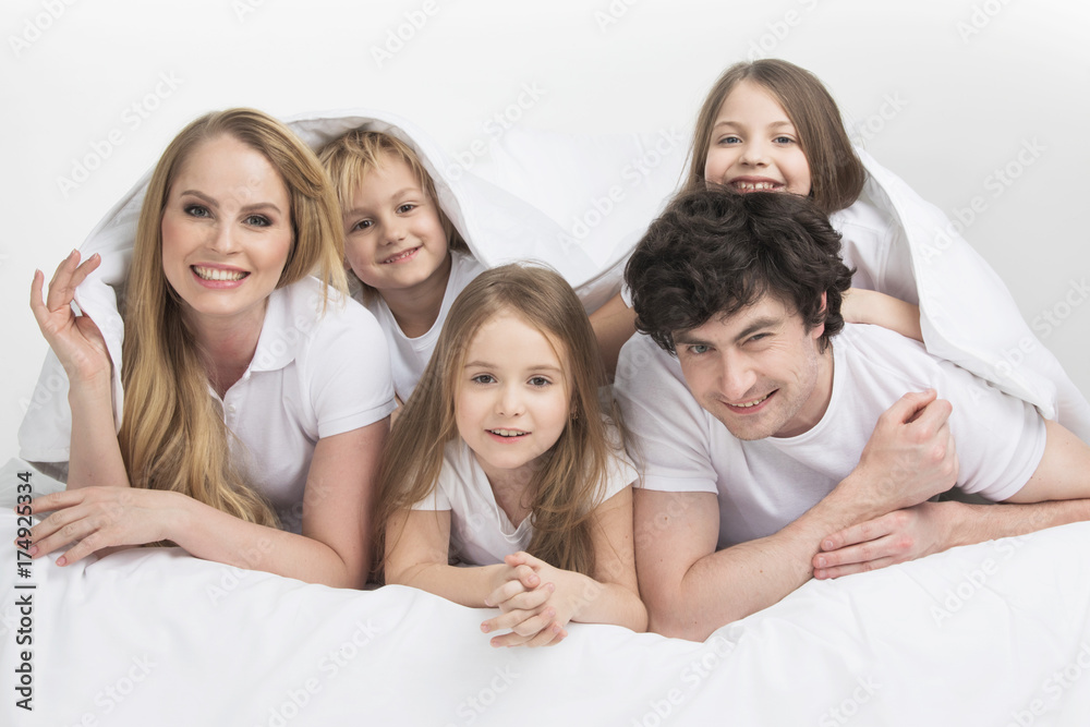 Smiling family in bed