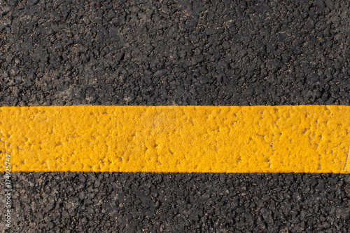 Yellow line on the road texture background