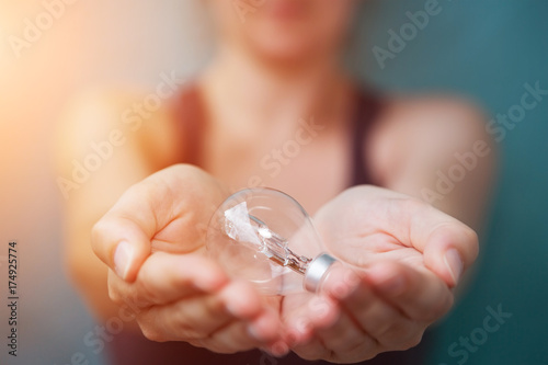 Businesswoman holding a lighbulb in her hand