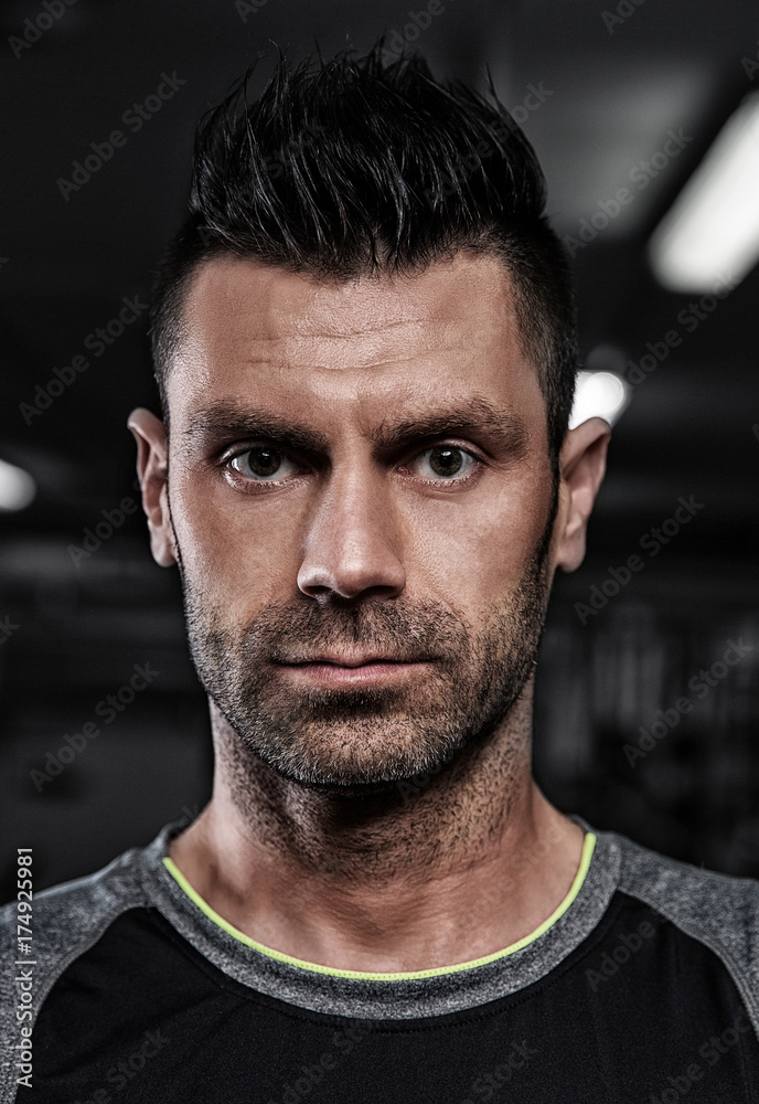 Portrait of sporty healthy strong muscle charismatic handsome man  bodybuilder in black and grey t-shirt outfit with brutal penetrating  serious look and nice creative modern hairstyle Stock Photo | Adobe Stock