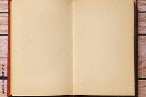 Opened notepad on top of a wooden board