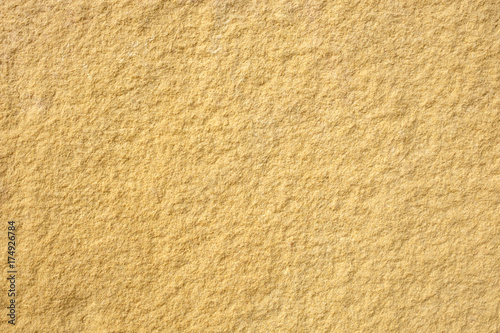 Details of yellow stone texture background.