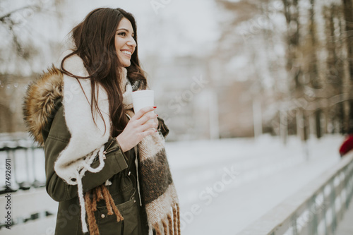 Pretty young woman drinking...