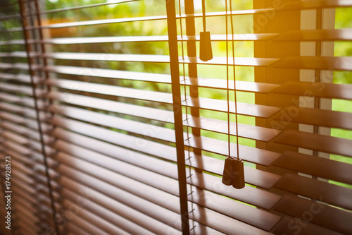 Wooden blinds with sun light.