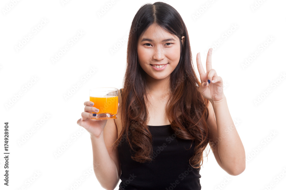 Young Asian woman show victory sign drink orange juice. Young Asian woman show victory sign drink orange juice.