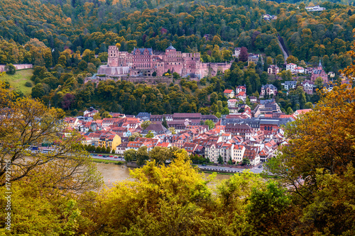 View on Heidelberg in autumn with red foliage including Carl Theodor Old Bridge, Neckar river, Church of the Holy Spirit, Germany