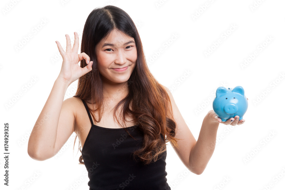 Asian woman show OK with pig coin bank. Asian woman show OK with pig coin bank.