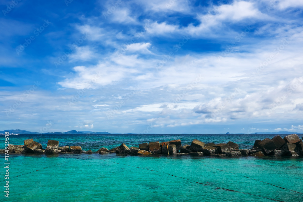 Dam rock on the sea with blue sky and clouds. Dam rock on the sea with blue sky and clouds.