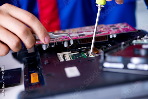 Repairman working in technical support fixing computer laptop tr