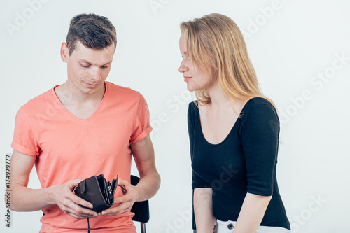 Nerdy man is trying to hide money from his wife because she want to spend it all photo