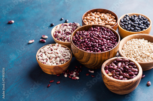 Assortment of beans on a blue background.