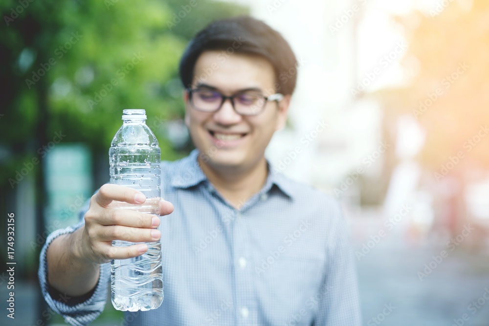 Young man drinking water from the bottle. Young man drinking water from the bottle.