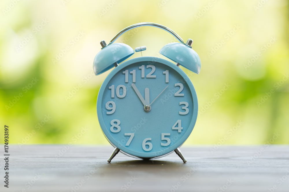 Retro alarm clock with five minutes to twelve o'clock. Retro alarm clock with five minutes to twelve o'clock.
