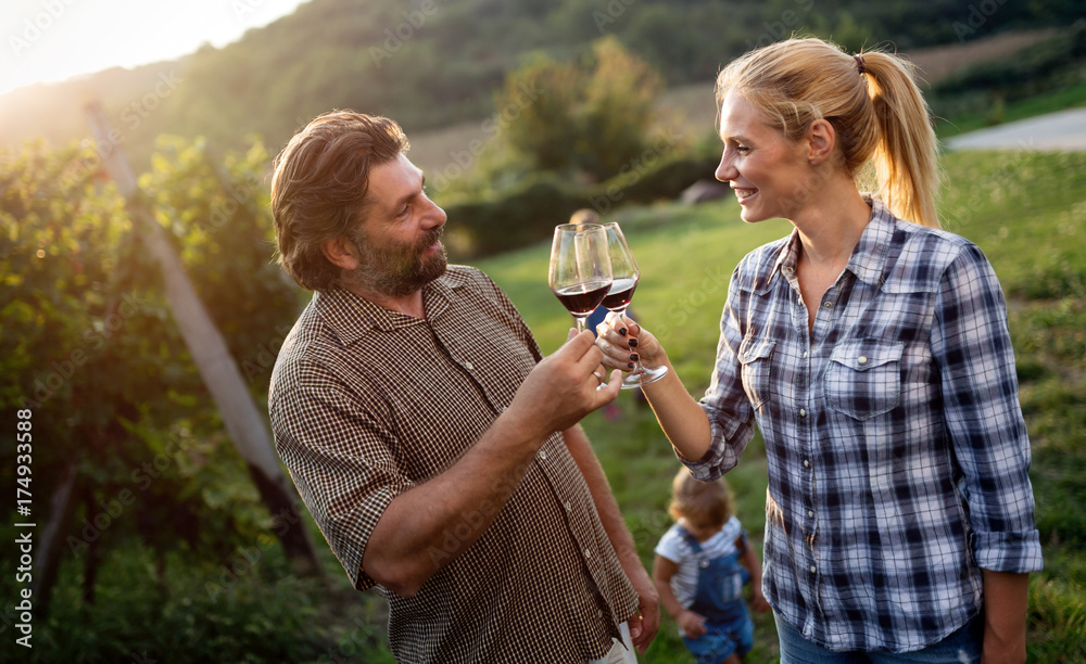 Fototapeta premium People tasting wine in vineyard
