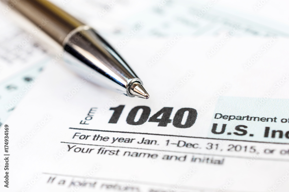 Pen on tax form 1040. Close up. Pen on tax form 1040. Close up.