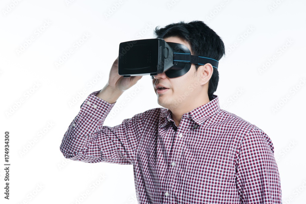 Man wearing virtual reality goggles excited mood. Studio shot, white background. Man wearing virtual reality goggles excited mood. Studio shot, white background.