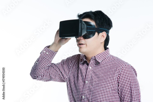 Man wearing virtual reality goggles excited mood. Studio shot, white background.
