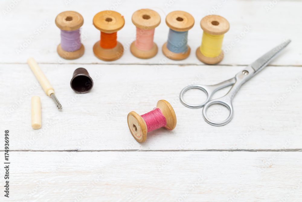 Accessories for handmade sewing on white wooden background Accessories for handmade sewing on white wooden background