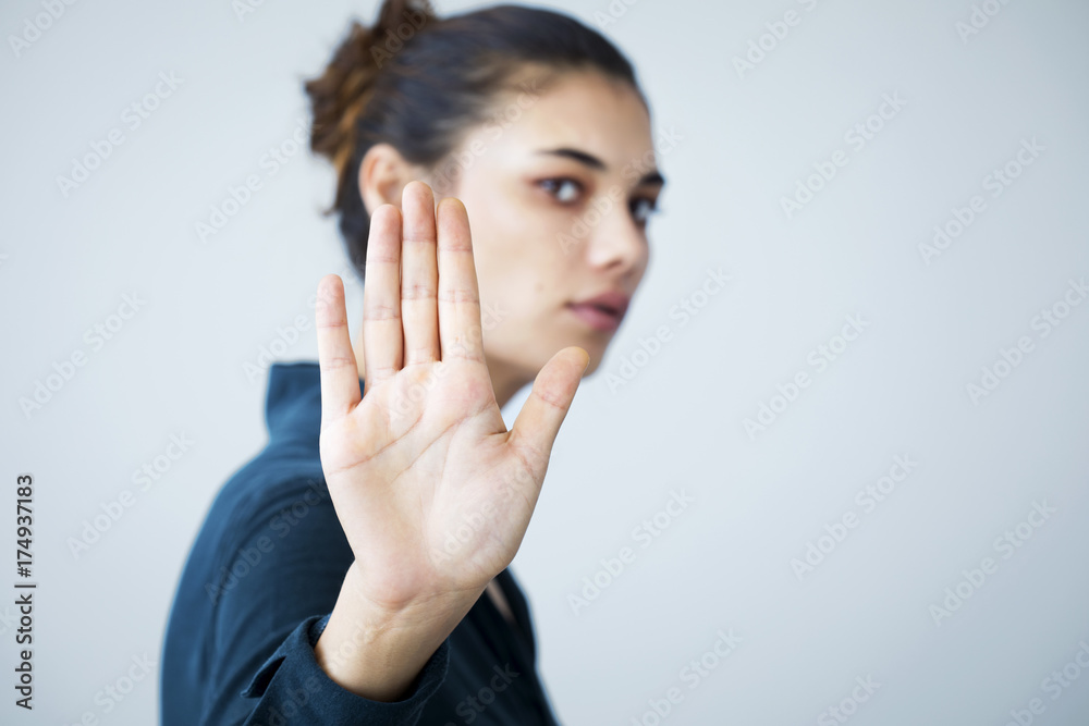 Woman making stop gesture with her hand - obrazy, fototapety, plakaty 