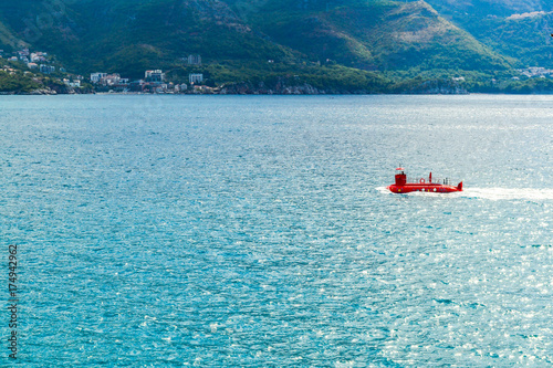 Sea view from the mountain. Adriatic Sea. A stylized red submarine floats by the sea. Montenegro