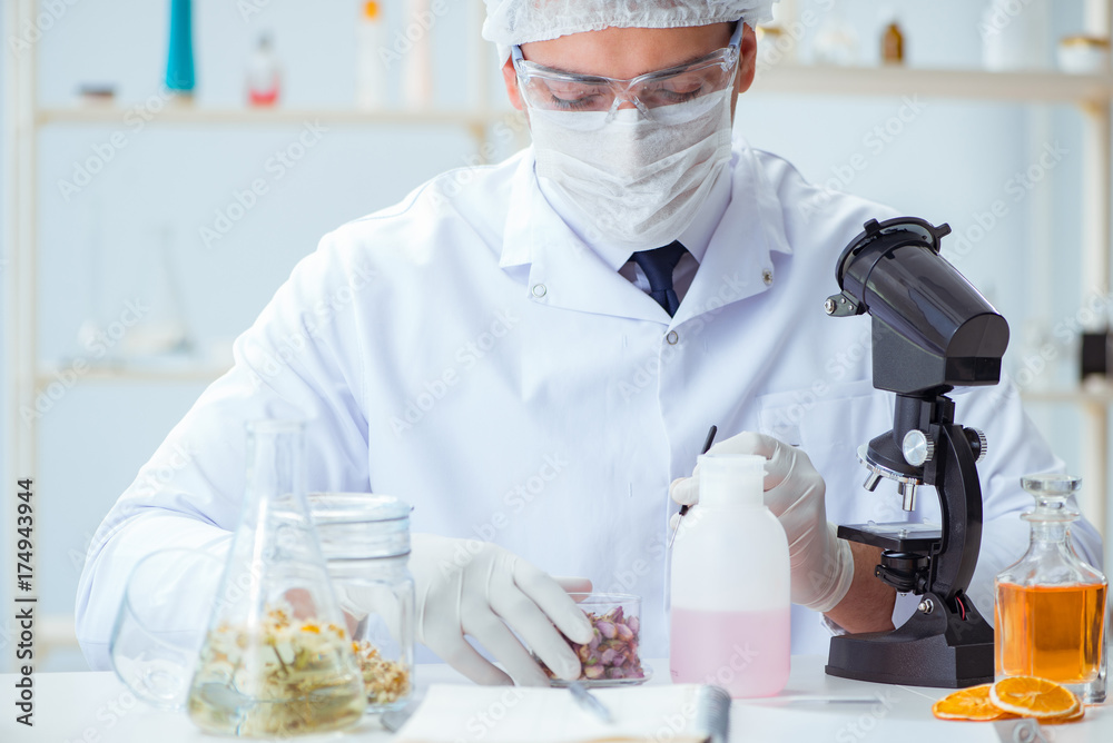 Chemist mixing perfumes in the lab Chemist mixing perfumes in the lab