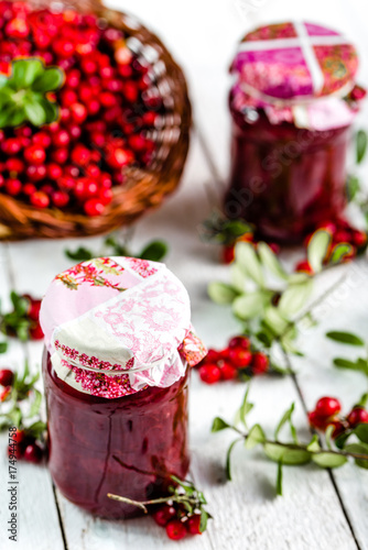 Red berry jam in a jar on table, natural organic product - homemade preserve for winter