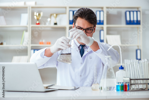 Young researcher scientist doing a water test contamination expe