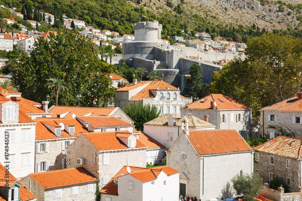 Traditional houses with red roofs and a symbol of the city - Minceta Tower. Dubrovnik, Croatia