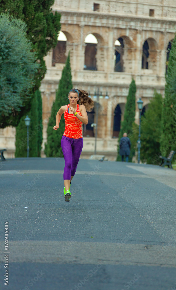 young healthy woman in sportswear in Rome, Italy running